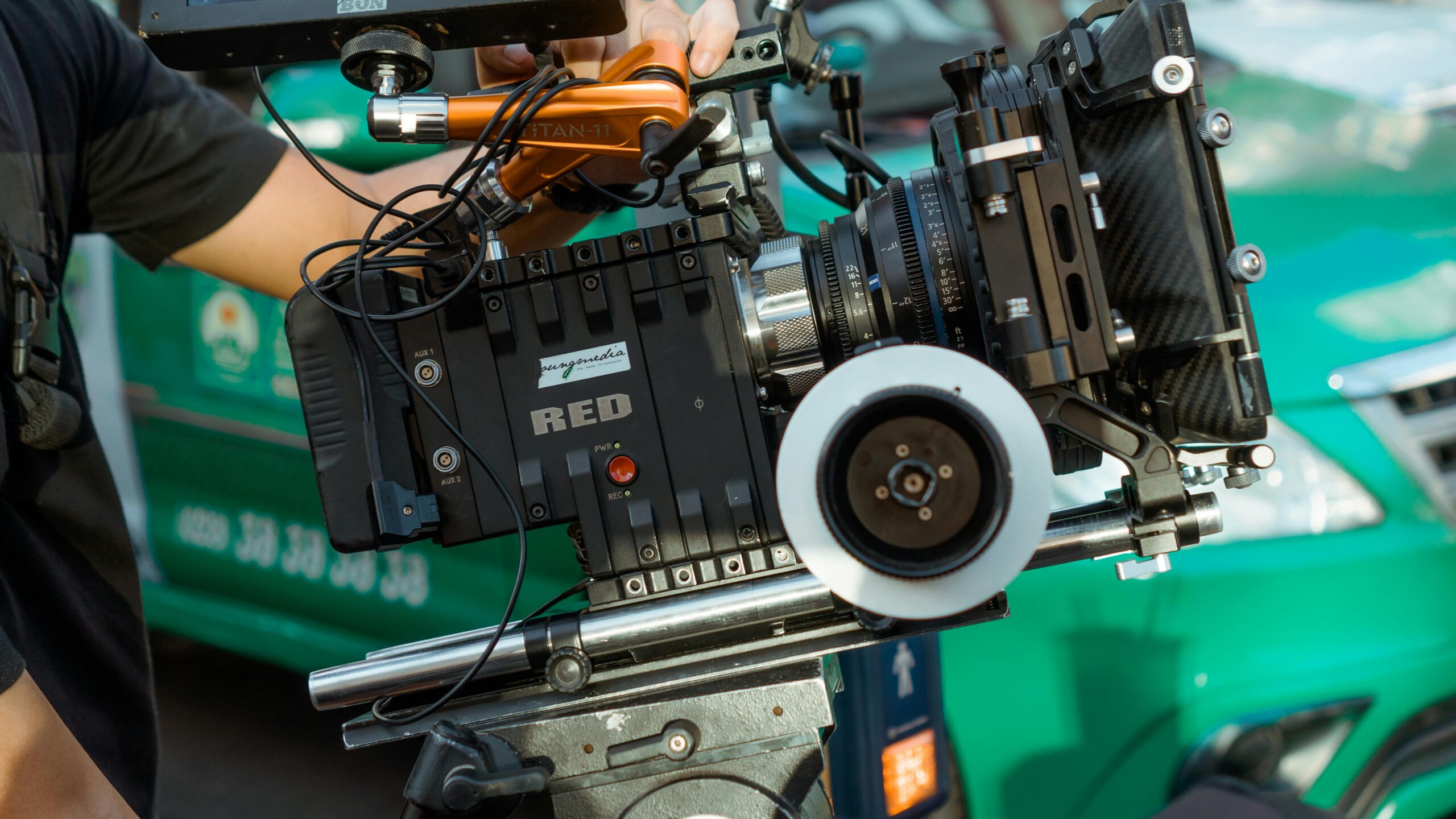 Close-up of a professional cinema camera rig on a sunny film set, showcasing advanced video gear.